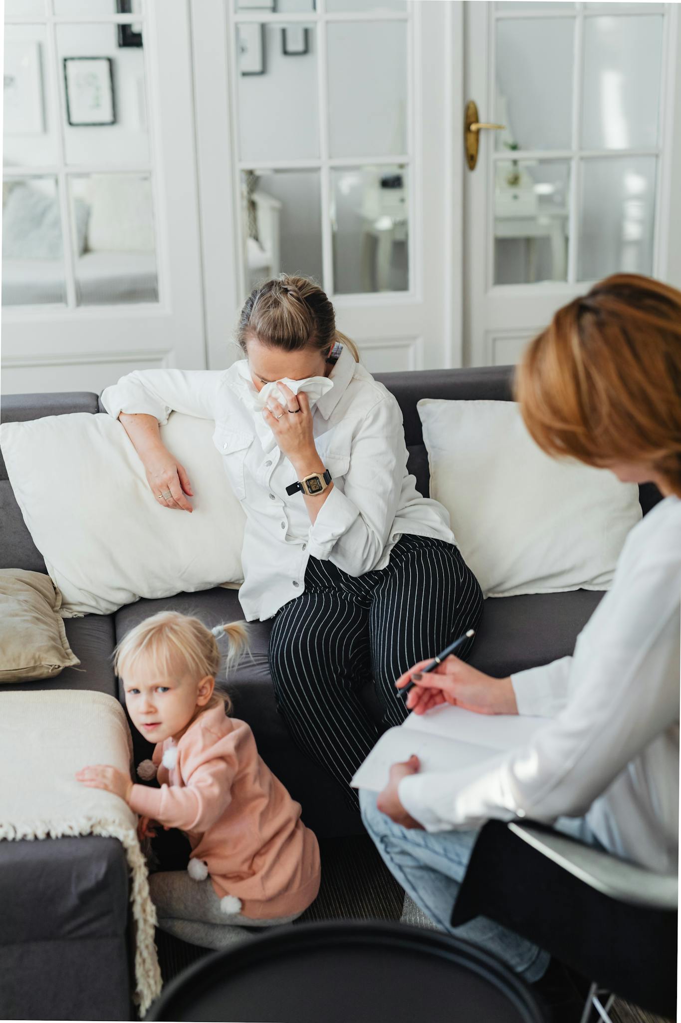 A candid moment during a family therapy session with a mother and child in a living room.
